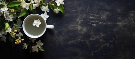 Aufkleber - Top view of a dark textured background featuring a captivating tea jasmine setting highlighted by a teapot leaves and flowers leaving abundant copy space for further additions