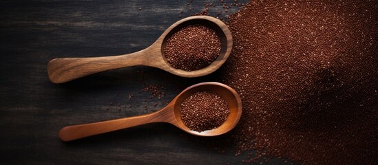Poster - A copy space image featuring healthy gluten free food consisting of coarse Ragi flour and red quinoa grain displayed on a rustic grey background with wooden spoons