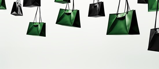 Poster - A view from below shows green and black paper shopping bags suspended against a white background creating a copy space image