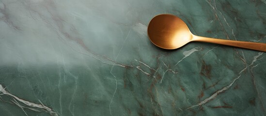 Aufkleber - Top view of a minimal style gold frame and square complemented with a wooden spoon placed on a green marble background The image provides ample text space