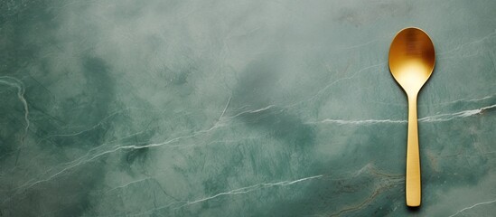 Aufkleber - Top view of a minimal style gold frame and square complemented with a wooden spoon placed on a green marble background The image provides ample text space