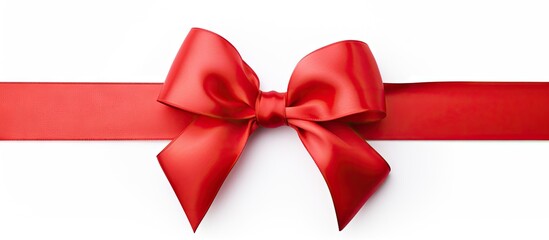 Poster - A red satin gift bow with a single ribbon isolated on a white background creating a copy space image