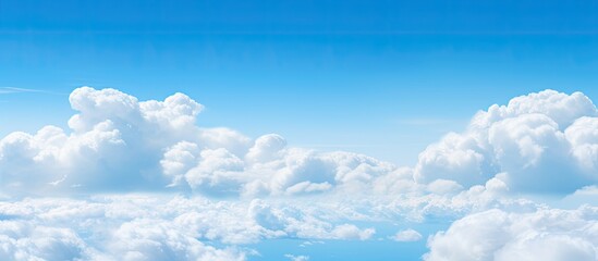 Naklejka na meble The copy space image showcases a serene atmosphere with a vivid blue sky adorned by fluffy white clouds