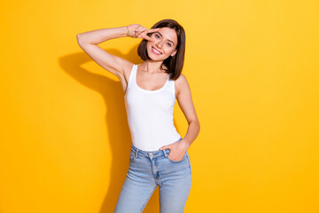 Wall Mural - photo portrait of attractive young girl show v-sign posing wear trendy white outfit isolated on yell