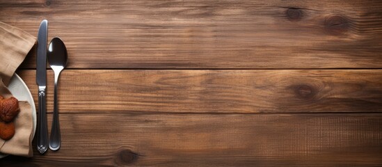 Poster - Fork Knife and Table Cloth on wooden background with Text copy Space empty black wooden table with cutlery