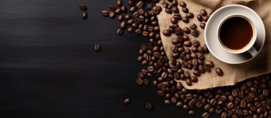 Poster - Coffee cup coffee beans and canvas bag on black table background Top view. copy space available