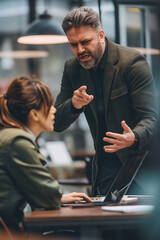 Angry office boss shouting, arguing and threatening his employee. Anger management concept.