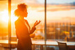 © VisualProduction - A confident businesswoman giving a presentation in a boardroom at sunset.