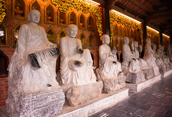 Wall Mural - Many Buddha statues in a hindu temple in Vietnam