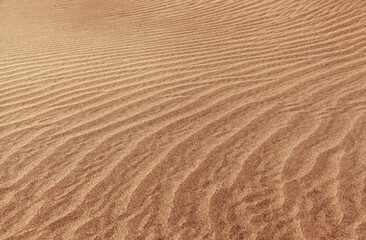  natural sand pattern created by wind blowing differently sized and colored particles