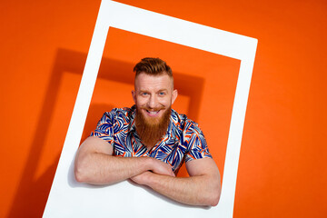 photo of cool cheerful guy with red beard wear print shirt posing in white frame hold arms crossed i