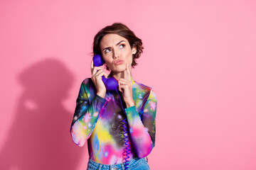 Portrait of pretty girl speak telephone look empty space wear pullover isolated on pink color background