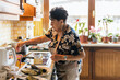 © ADDICTIVE STOCK - Elderly Lady Preparing a Meal in a Homely Kitchen