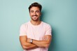 © Markus Schröder - Portrait of a grinning man in his 30s with arms crossed on pastel or soft colors background