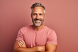 © Markus Schröder - Portrait of a happy man in his 40s with arms crossed in front of pastel or soft colors background