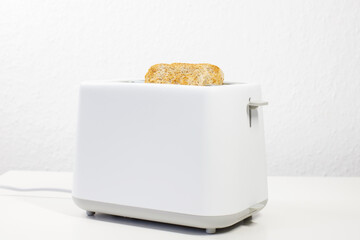 Wall Mural - toaster with bread inside on the table. breakfast, lunch. slices of bread. toaster bread.