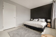 © ADDICTIVE STOCK - Modern bedroom interior with elegant dark accent wall