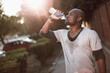 © Geber86 - African American man drinking water after outdoor exercise session
