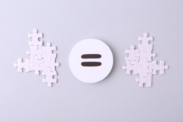 Wall Mural - Puzzle pieces and equals sign on light background, flat lay