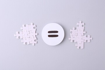 Wall Mural - Puzzle pieces and equals sign on light background, flat lay