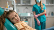 © amila - Upset Little Girl Laying Back on Dentist Chair, Female Dentist is about to Check Her Dental Hygiene and Tooth Cavities in Clinic