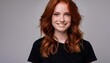© Marko - Closeup of happy attractive young woman with long wavy red hair and freckles wears stylish t shirt looks happy and smiling isolated over white background