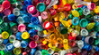 © VicenSanh - A pile of colorful plastic caps and lids. The caps are of different colors and sizes. Concept of abundance and variety