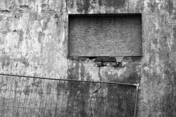 Wall Mural - Grungy metal fence against dirty weathered cement wall.