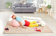 © Studio Romantic - Funny lazy tired man takes a nap while working out. Weak weary young man in retro sports clothes and headband resting his head on yoga ball while sleeping on floor in living room after fitness workout