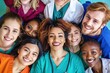 © ProPhotos - An international group of healthcare workers, including doctors and nurses, stand together and smile at the camera. They are all dressed in scrubs, in the center there is a girl African-American docto