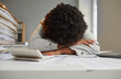© Studio Romantic - Tired burned out African American woman hides her face in hands and lays weary head with Afro hair on desk, exhausted by red tape paperwork piles, feeling stuck in this goddamn office. Burnout concept
