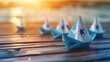 © Ahtesham - Blue Paper Boat Leading A Fleet Of Small White Boats With Compass Icon On Wooden Table With Sunlight - Leadership Concept realistic