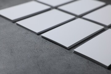 Wall Mural - Blank business cards on grey textured table, closeup. Mockup for design