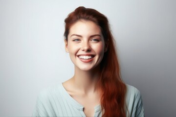 Wall Mural - smiling beautiful young woman against white background