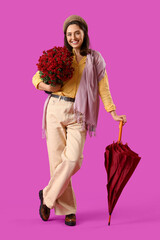 Wall Mural - Young woman with chrysanthemum flowers and umbrella on purple background