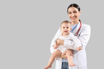 Sticker - Female pediatrician with little baby on light background