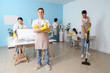 © Pixel-Shot - Group of young janitors cleaning in office