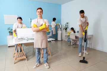 Poster - Group of young janitors cleaning in office