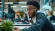 © yj - A young afro professional man is sitting at his desk in the office. He is having meeting or conference call with other people on computer screen. generative AI