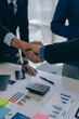 © ArLawKa - Business people shaking hands and meeting with the above documents to hire a partner or work together at the office in recruiting. Teamwork or research of a close-up marketing projec