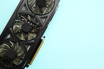 Poster - One graphics card on light blue background, top view. Space for text