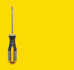 Screwdriver tool in hand, long handle and head for screw driving. Yellow background with promotional space in banner. Business advertising for builder, carpenter, mechanic repair and maintenance.