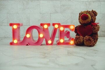 Sticker - Pink Love LED Decorative and teddy bear with red heart on marble background