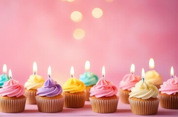 Wall Mural - birthday cupcakes with a candles on a pink background with copy spase