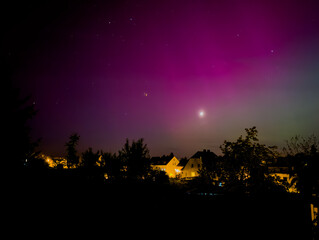 Wall Mural - aurora over the city in the night in germany, vogtland saxony