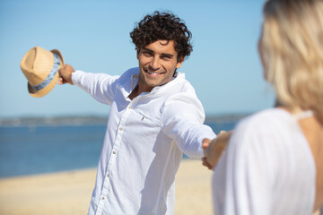 happy couple dancing at beach