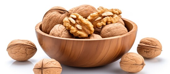 Wall Mural - A top view of a bowl of walnuts isolated on a white background providing copy space for adding text or images to the image