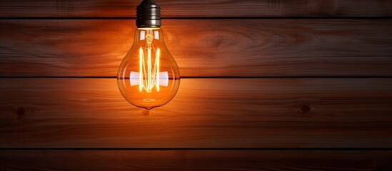 Poster - A concept of a unique glowing bulb showcased on a brown wooden wall with plenty of copy space image
