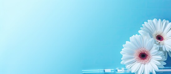 Poster - Copy space image featuring a light blue background adorned with a medical syringe a gerbera flower and cosmetology theme