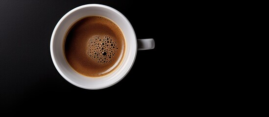 Poster - The black background highlights a top view of a coffee cup creating a perfect copy space image for adding text